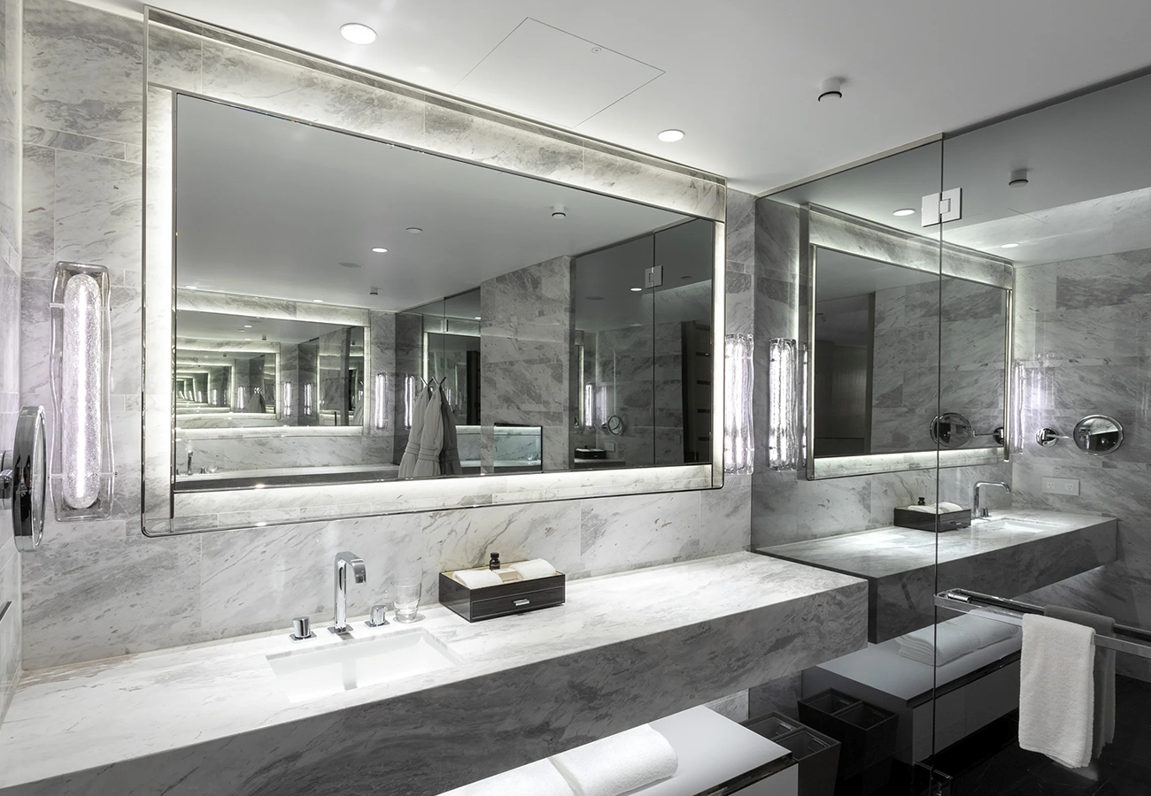 A modern bathroom with a large custom mirror