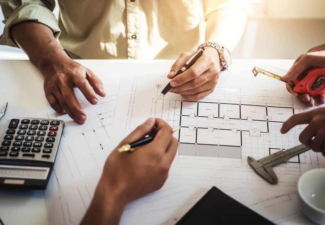 A project manager reviewing architectural plans.